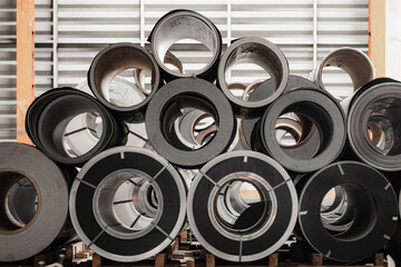 Metal sheet roll, steel sheet roll stock pile storage warehouse heavy industry manufacturing plant.