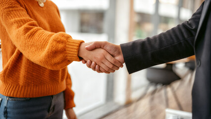 close up of casual handshake between people showing trust partnership cooperation agreement and mutual understanding in friendly business or teamwork context