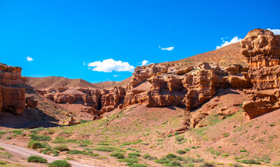 Fototapeta premium Charyn Canyon, Valley of Castles. The excellence of Kazakhstan. Panorama of natural unusual landscape. The red canyon of extraordinary beauty looks like a Martian landscape.