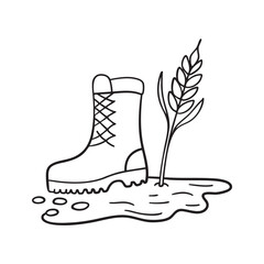 A wheat sprig beside a boot print left in the mud