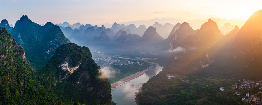 Aerial view of the beautiful karst mountains and river natural landscape with morning fog at sunrise in Guilin, China. - Powered by Adobe