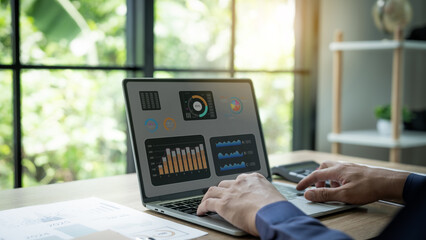 Businessman uses computer and writes financial data, budget planning, accounting, tax calculation and financial management for corporate finance.