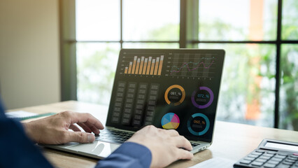 Businessman uses computer and writes financial data, budget planning, accounting, tax calculation and financial management for corporate finance.