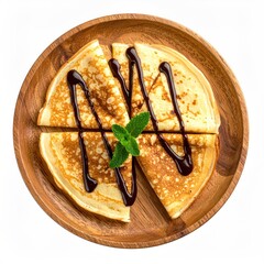 Crepes drizzled with chocolate sauce, wooden plate, mint