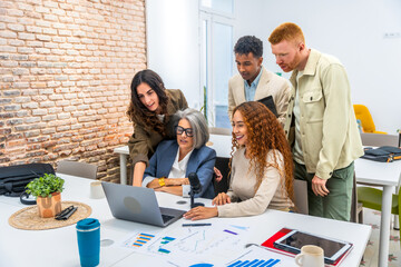 Diverse business team collaborating during office meeting, analyzing data