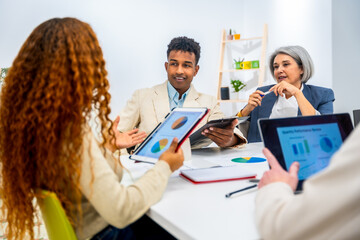 Diverse business team analyzing data during office meeting