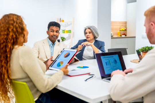 Diverse business team analyzing data during office meeting