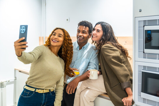 Diverse colleagues taking a selfie during coffee break