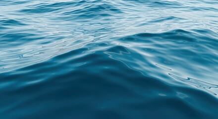 Vibrant blue water surface with gentle ripples and reflections, creating a soothing natural backg...