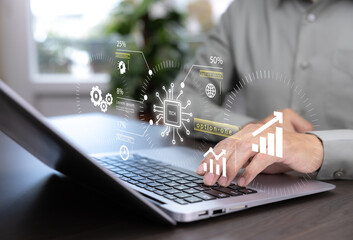 Businessman using laptop with digital data analytics dashboard. Concept of big data, technology, business intelligence, financial growth, innovation, and modern digital solutions.