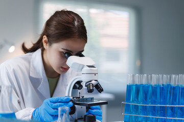 Female scientist doing research using microscope