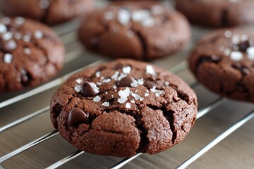 Fototapeta premium Double Chocolate Cookies with Dark Chocolate Chips, Salt Flakes on Cooling Rack