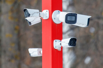 A pole with four security cameras on it