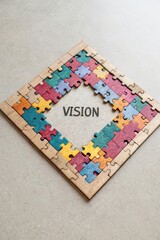 Colorful Puzzle Pieces Framing The Word Vision On A Surface
