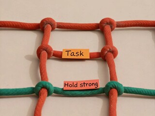 Colorful knots and labels on a rope grid for task management