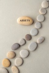 Smooth Pebbles With Text Asset Representing Financial Growth Concept