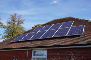 Bungalow style house in the UK with solar panels on roof. Alternative clean energy source for homes 