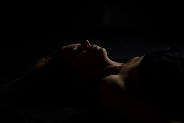 Woman receiving relaxing shoulder massage in dimly lit spa environment