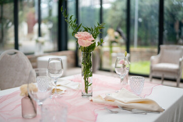 Elegant private event venue table setting prepared for an intimate lunch gathering with delicate floral arrangements and soft ambient lighting creating a sophisticated atmosphere