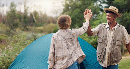 Couple, camping and high five by tent, excited and smile for achievement, goals or holiday in nature. People, man and woman in woods with interracial love, celebration and pitch shelter for vacation.