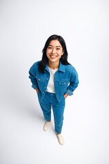 Smiling Young Woman in Denim Outfit Posing in Bright Studio
