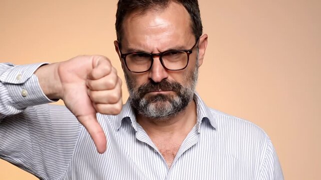 Man with Beard and Glasses Giving a Thumbs Down Disapproval Negative Feedback Rejection Business Concept