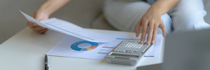 woman organizes tax invoices at home to streamline her financial budget planning