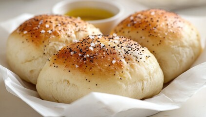 Shiny bread rolls with salt and seeds, served on paper