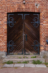 Historic wooden double doors in a brick building
