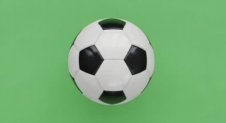 Top-down view of a classic black and white soccer ball on a vibrant green background, perfect for sports and leisure themes