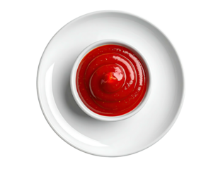 Overhead shot of a white bowl filled with red sauce on a white plate
