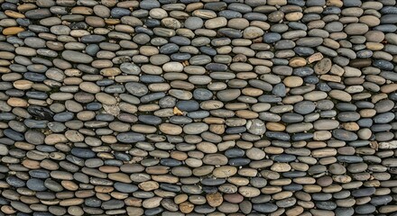 Close-up of tightly packed smooth river pebbles forming a natural textured background or decorative surface