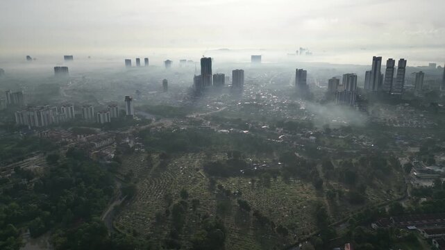 A city with a foggy sky. The sky is gray and the city is full of buildings. Aerial view Larkin, Johor