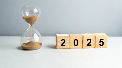 2025 end of year review new planning concept hourglass and wooden blocks with numbers on clean surface conveying time passing and reflection