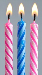 Three birthday candles burning brightly