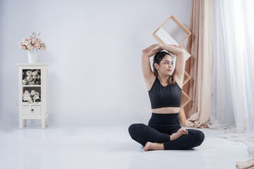 Beautiful Asian woman doing fitness indoor
