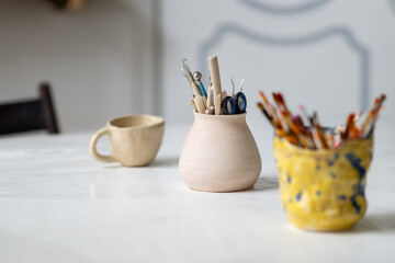Brushes, stacks and styluses for creativity in a clay pot