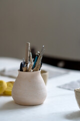 Brushes, stacks and styluses for creativity in a clay pot