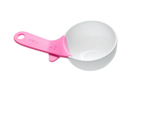 A white and pink measuring cup, handle pointing left, isolated on black