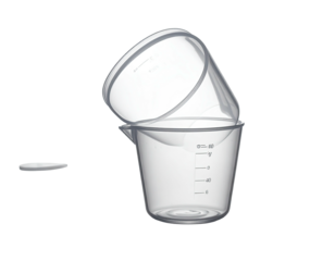 Two clear, plastic measuring cups stacked, and a lid on a plain black background