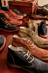 Stylish collection of men's shoes displayed on a wooden surface.