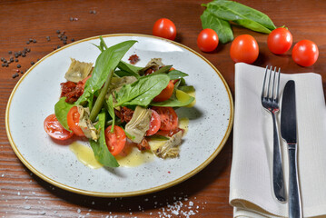 fresh salad with tomatoes and spinach on a table with food decor