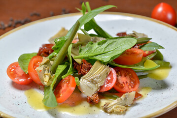 fresh salad with tomatoes and spinach on the table macro photo