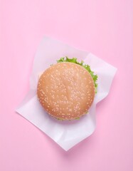 Top-down view of a burger on white paper