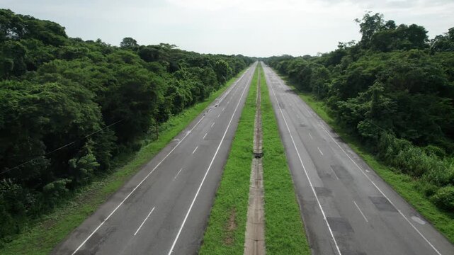 Long Empty Highway Road Cutting Through the Amazonian Green Forest Landscape