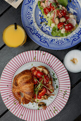 Croissant with filling on a beautiful plate isolated