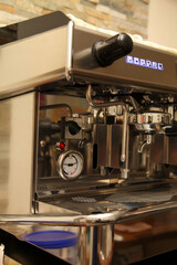 Close-up of a professional espresso machine with detailed stainless steel components.