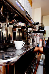 Espresso machine with a cup in a cafe