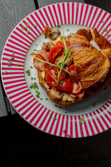 Croissant with filling on a beautiful plate isolated