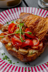 Croissant with filling on a beautiful plate isolated